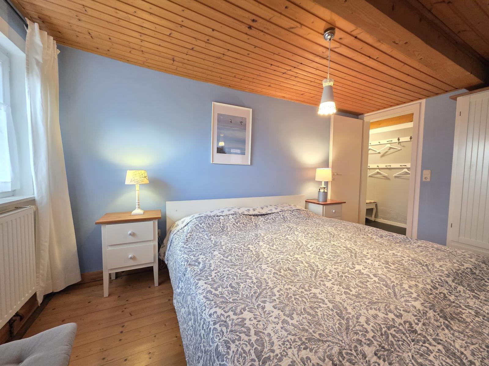 Bedroom with double bed, nightstands, and closet.