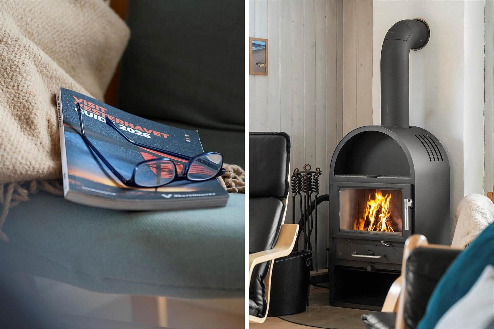 Ein Buch und Brille auf einem Sitzplatz. Ein Kamin mit brennendem Holz.