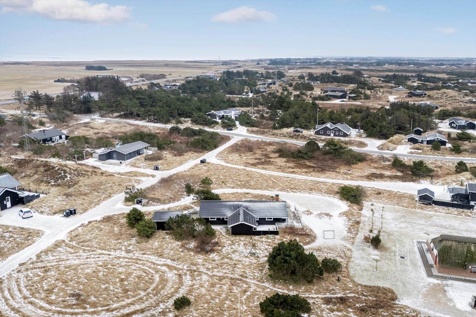 Aerial view of a residential area with multiple houses and winding paths.