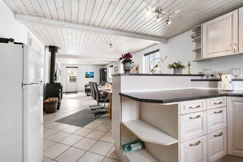 Kitchen with countertop and dining area in the background.