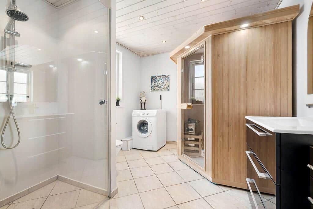 Shower, sauna, and washing machine in bathroom