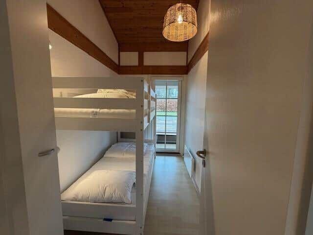 Zimmer mit Doppelstockbetten und Holzdecke