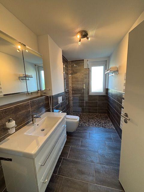 Bathroom with shower, sink, and toilet