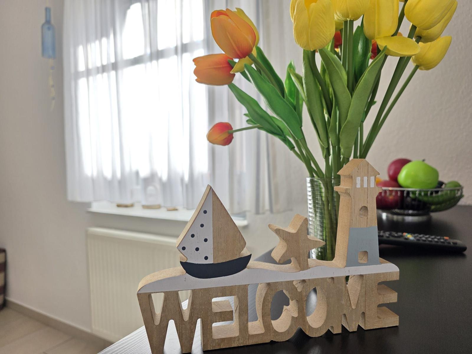 Welcome decoration with flowers and fruit on a table.
