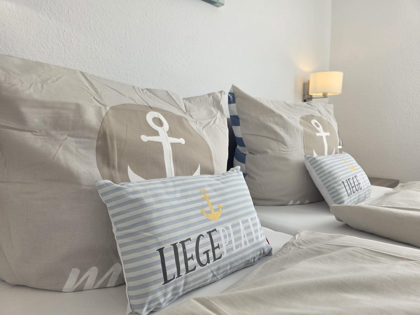 Bed headboard with pillows and wall lamp