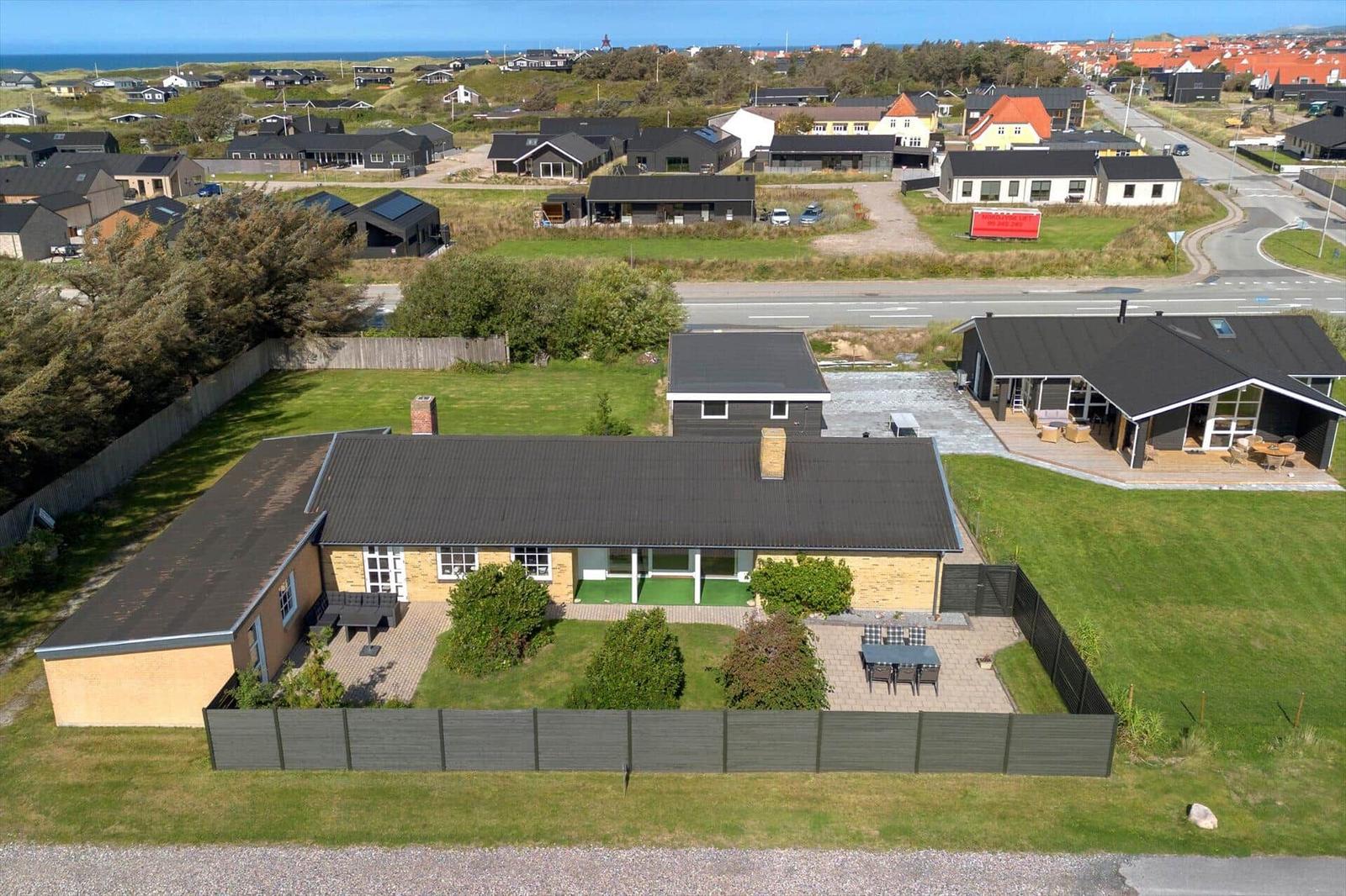 Modern house with garden, terrace, and sea view.