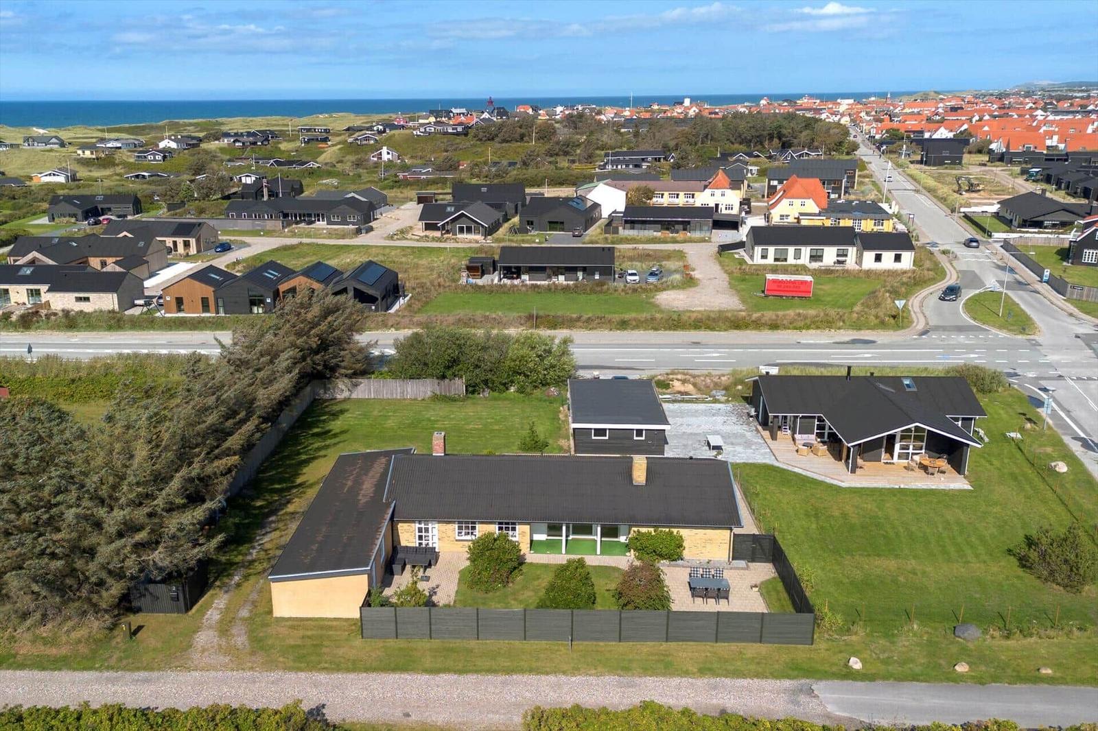 Modern vacation home with large garden and coastal view.