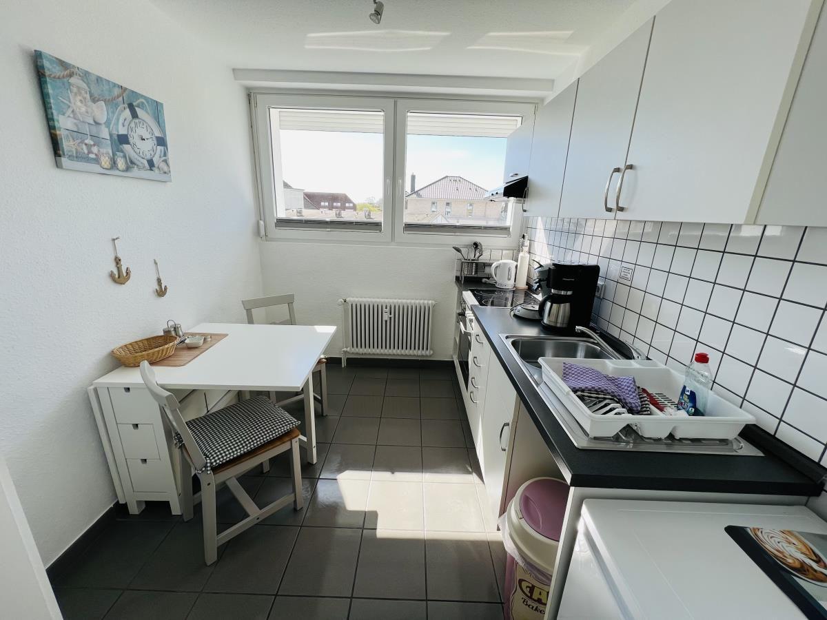 Kitchen with dining table, window, and sink