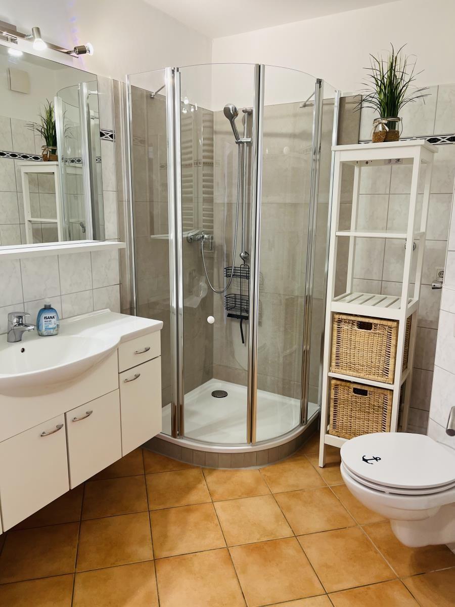 Bathroom with shower, sink, and toilet.