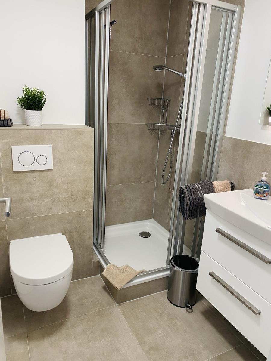 Bathroom with shower, toilet, and sink