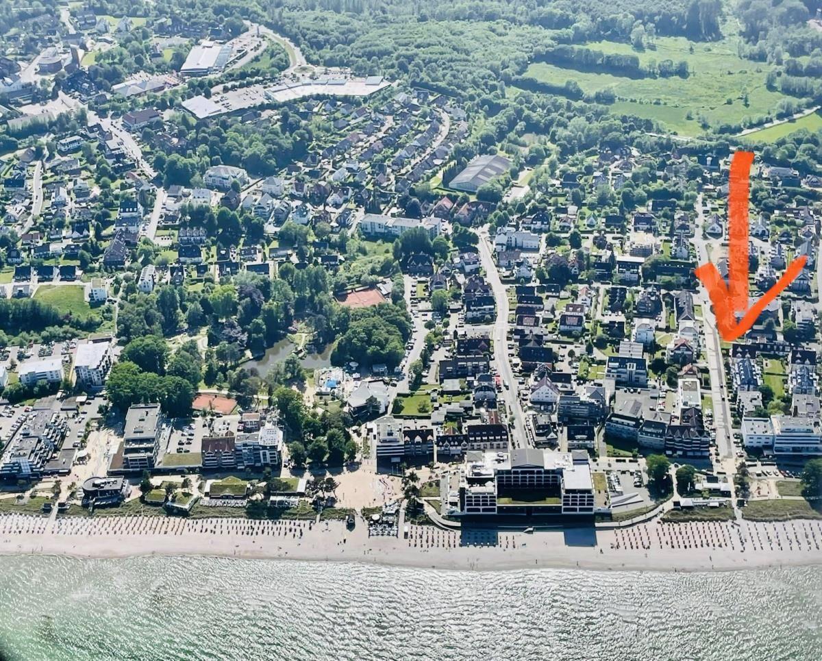 Aerial view shows beach, neighborhood, and marked location.