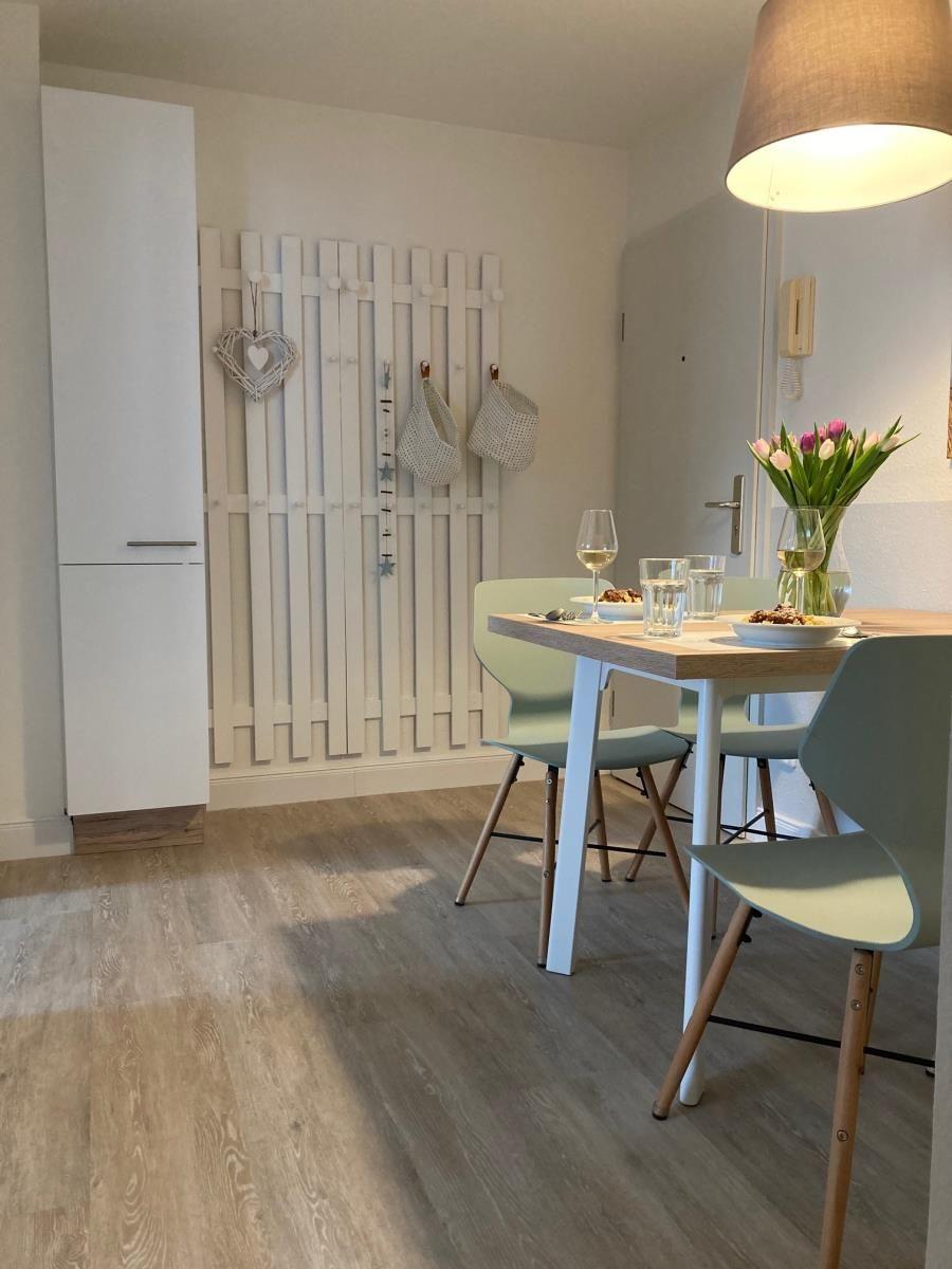 Dining area with table, chairs, and flower arrangement