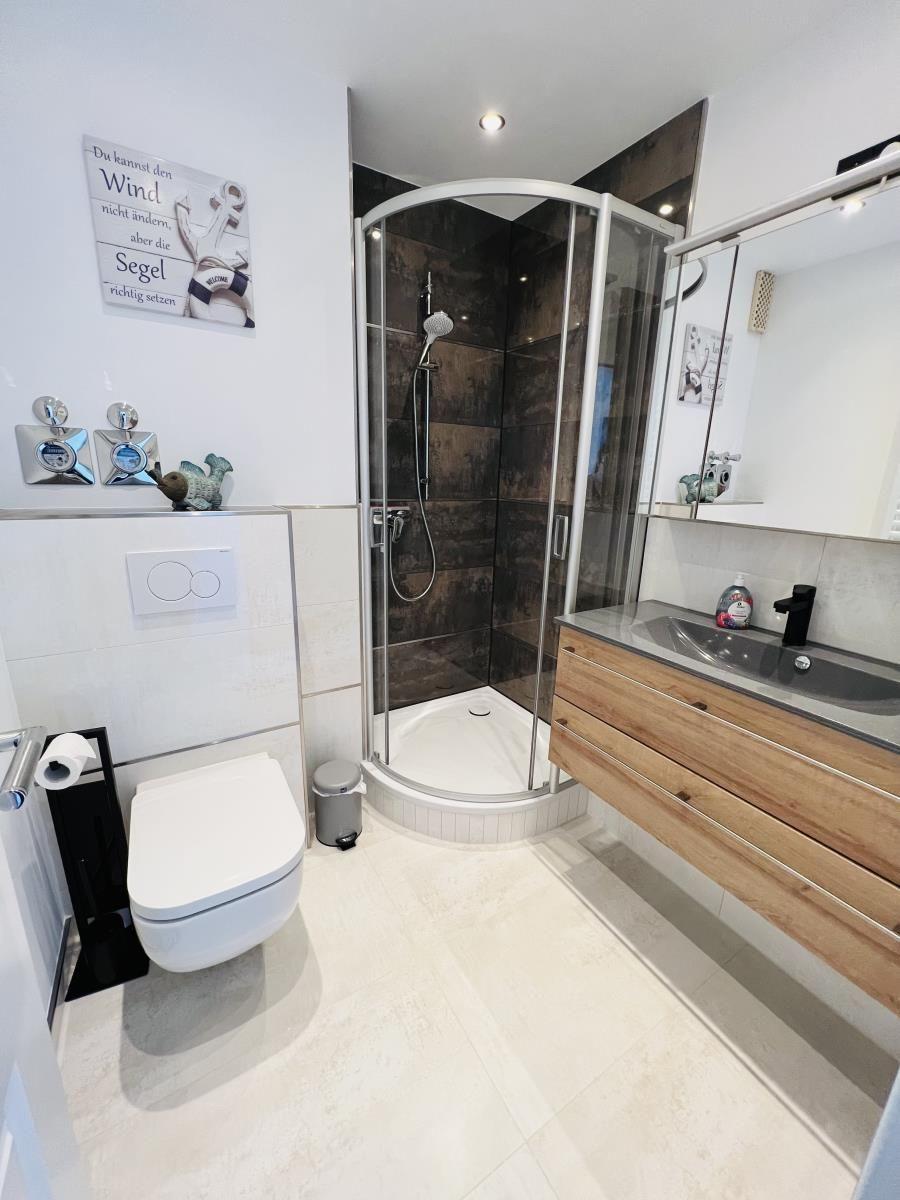 Bathroom with shower, sink and toilet.
