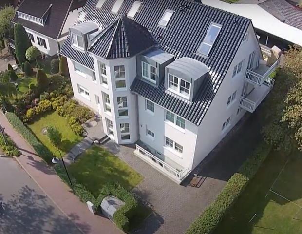 White villa with rooftop terraces and landscaped garden. 