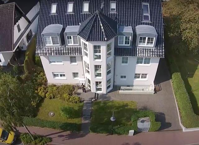 House with dormers and landscaped garden area viewed from above