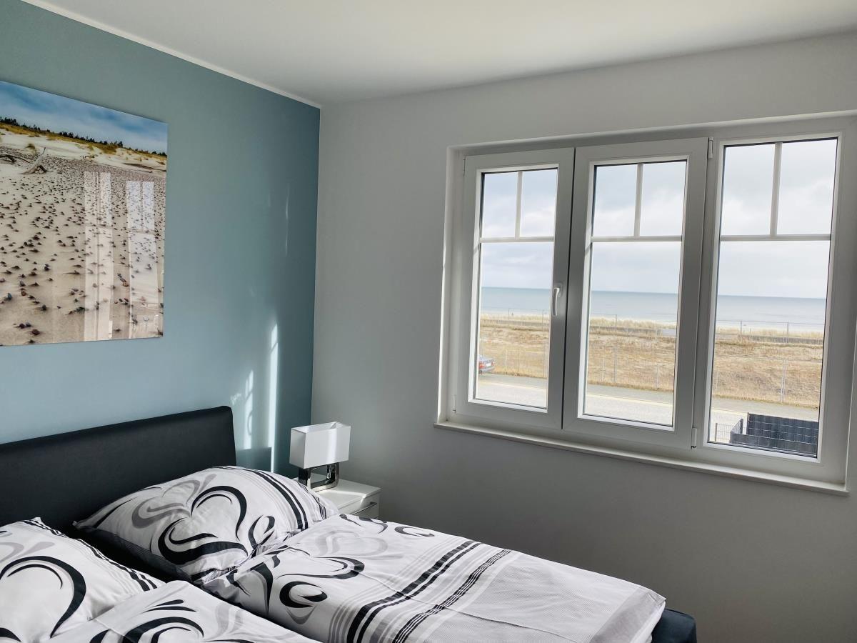 Bedroom with sea view and wall picture