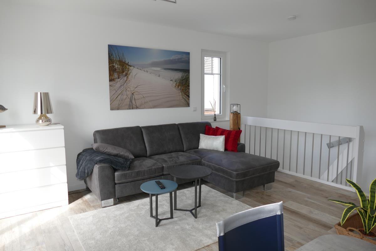 Living room with gray sofa, small table, and wall art