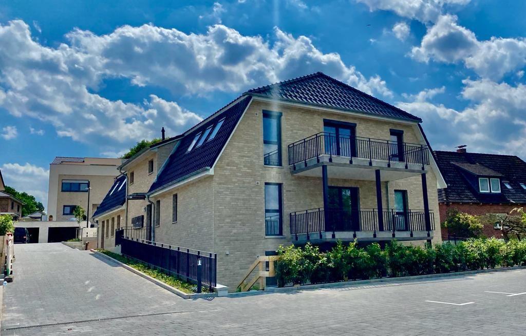 Modern house with balconies and skylights under blue sky.