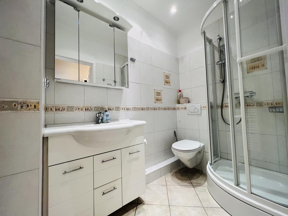 Badezimmer mit Dusche, Waschbecken und Toilette