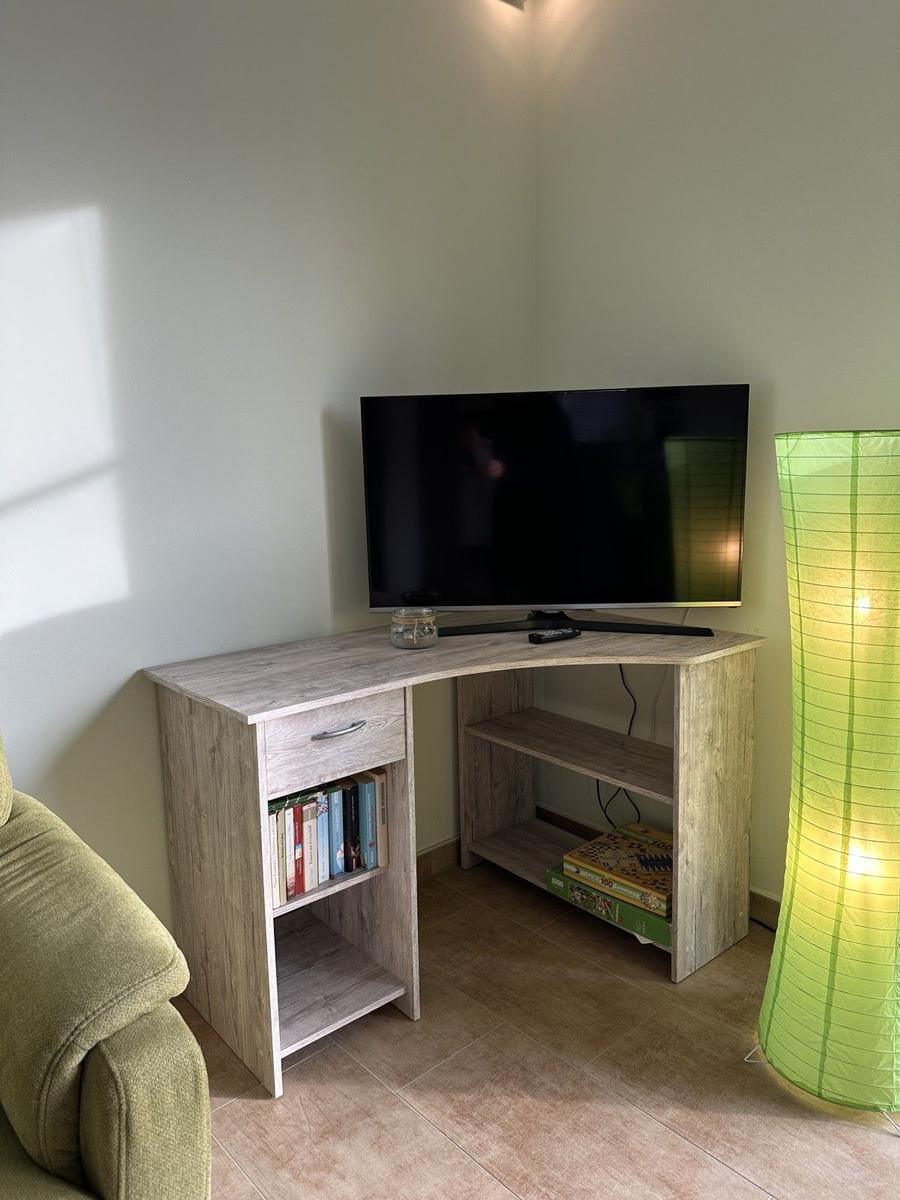 TV-Tisch mit Regal und Lampe im Wohnbereich