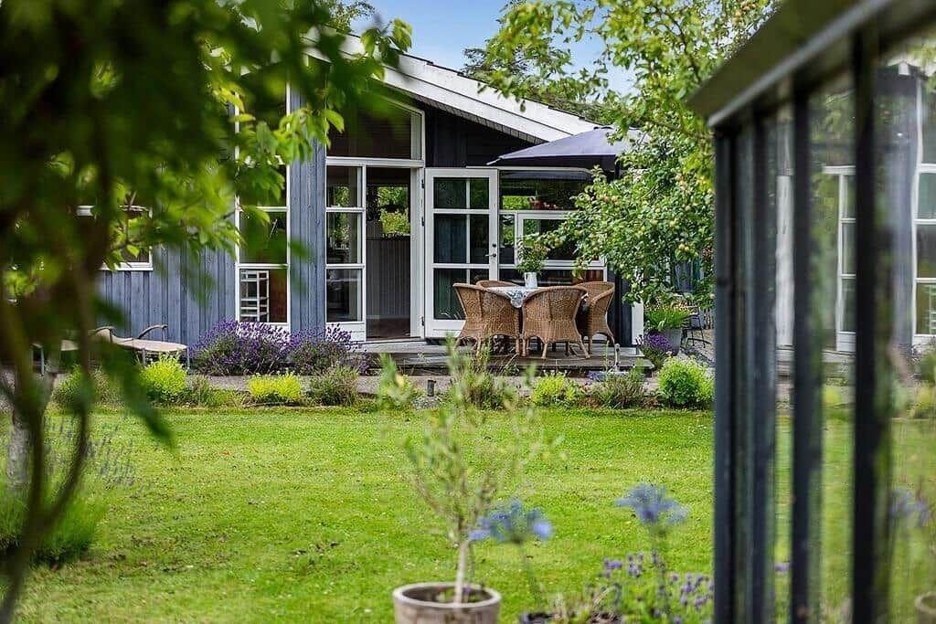 House with terrace, garden, and outdoor seating.