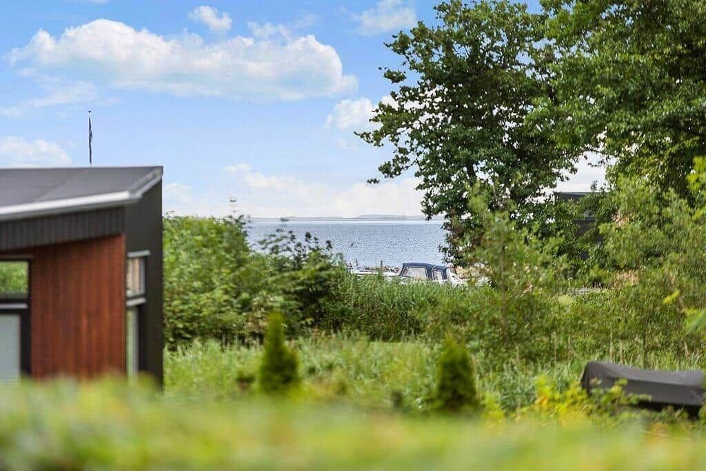 House with view of water and green garden