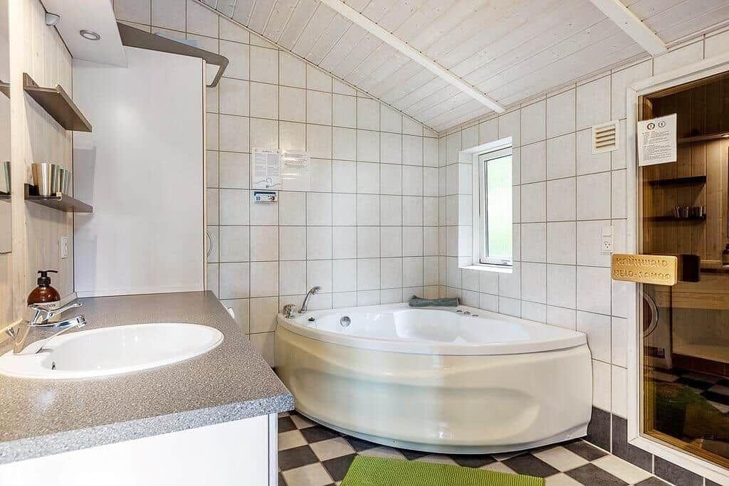 Bathroom with bathtub, sink, and shower