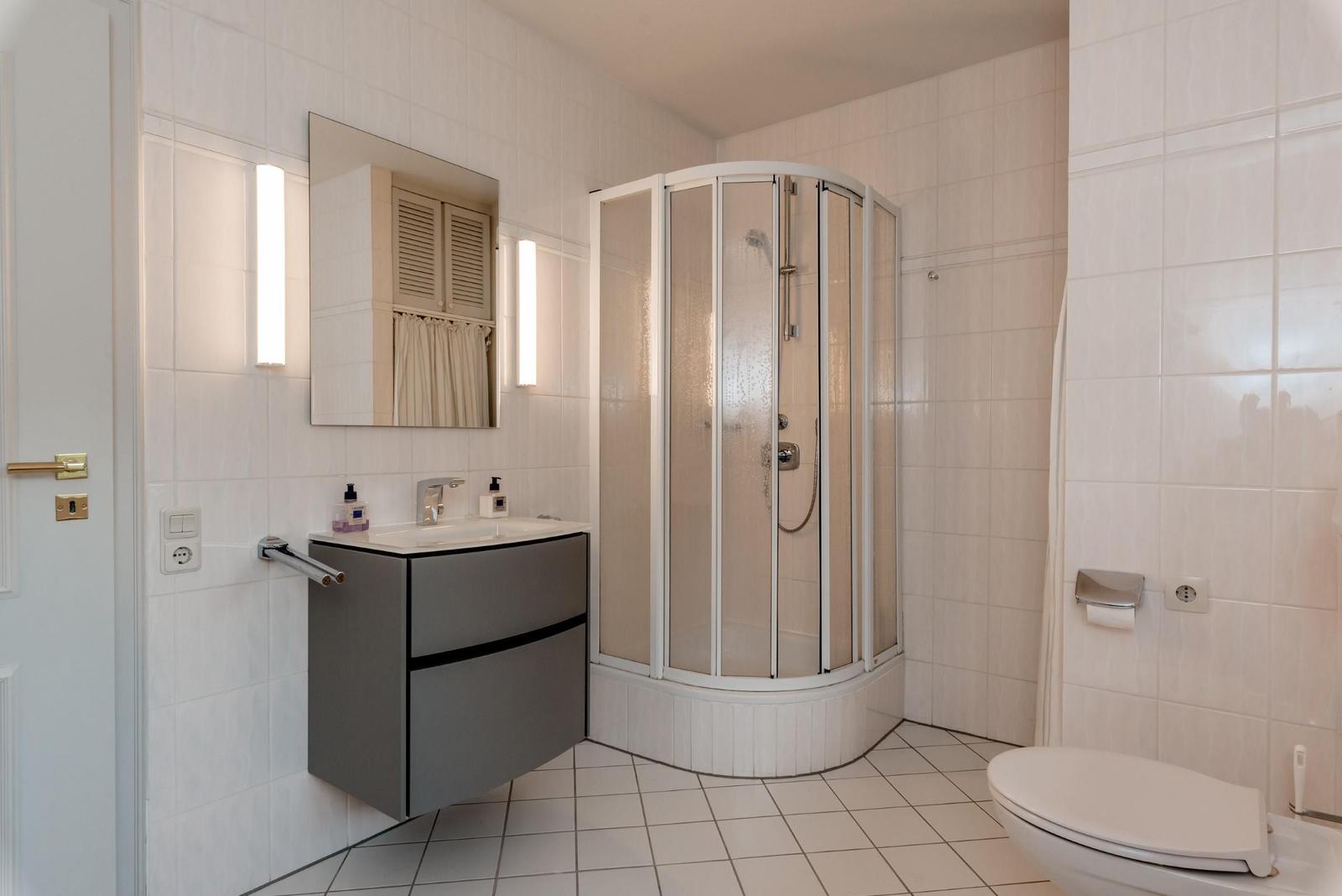 Bathroom with shower, sink, and toilet.