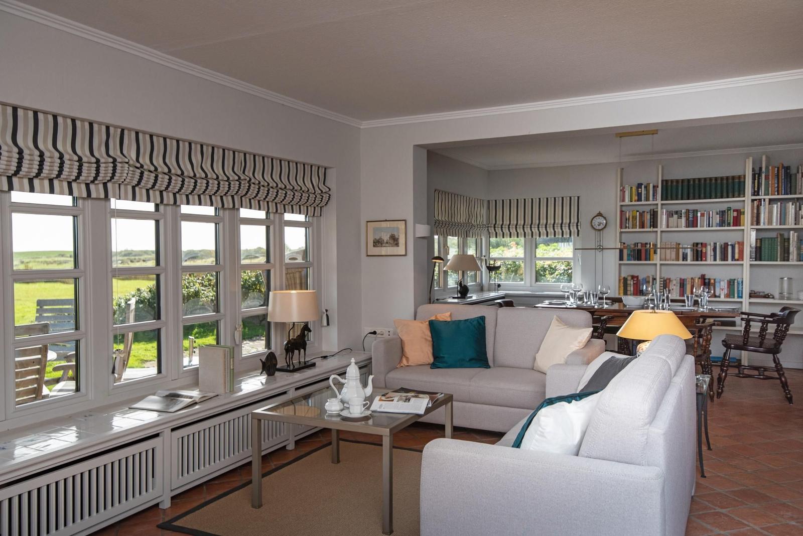 Living room with sofa, coffee table, and garden view