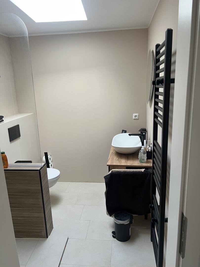 Bathroom with shower, sink, and heater