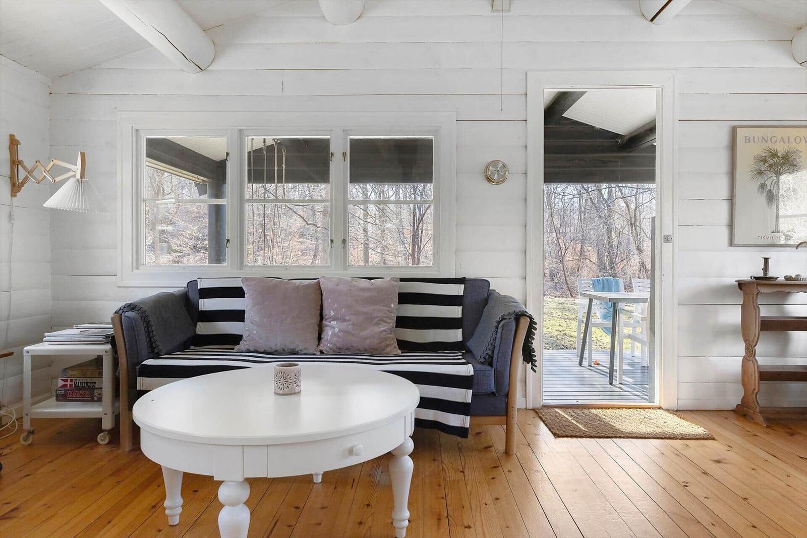 Living room with sofa, table, and view of terrace
