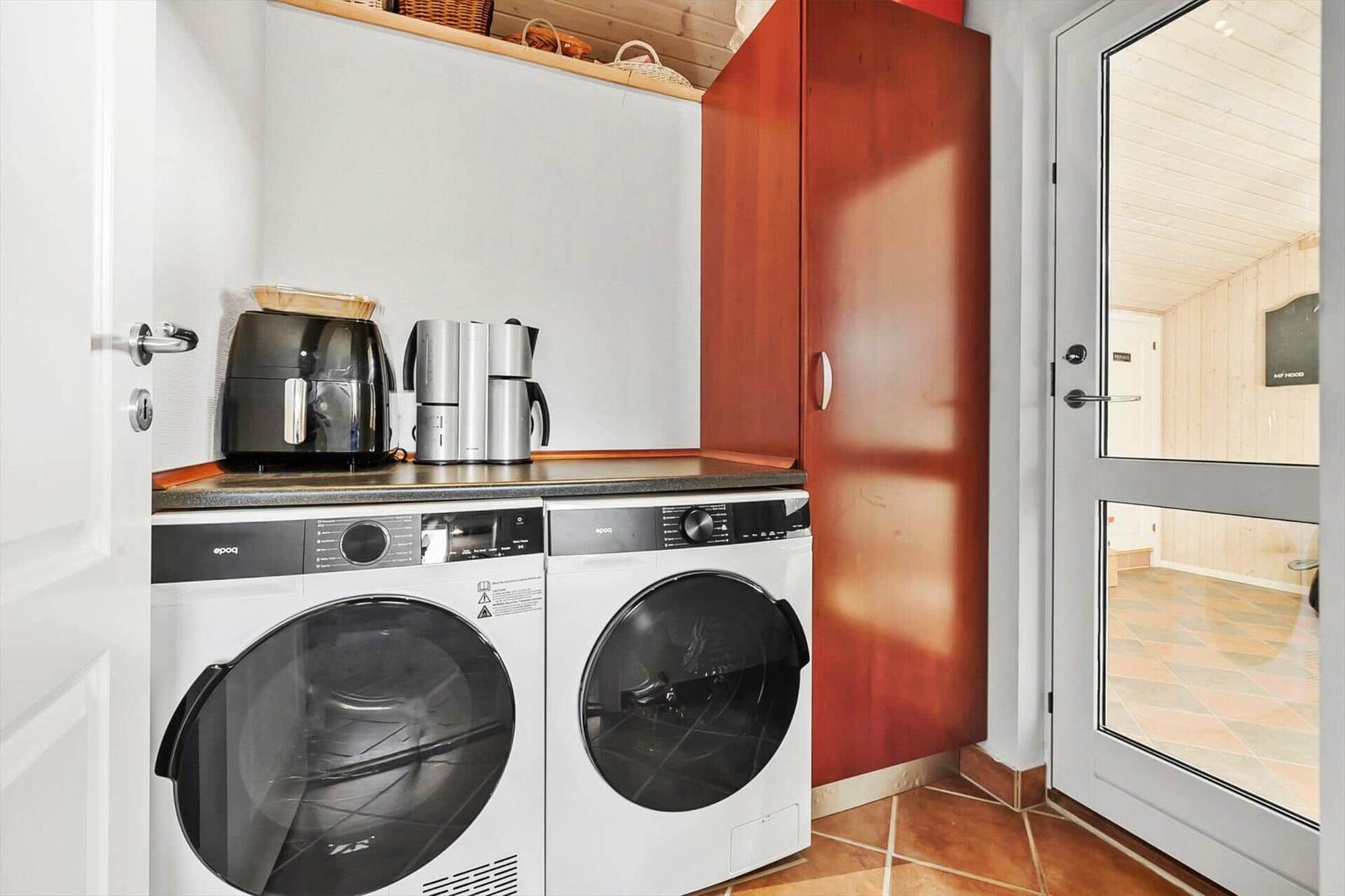 Washing machine and dryer with coffee maker and refrigerator.