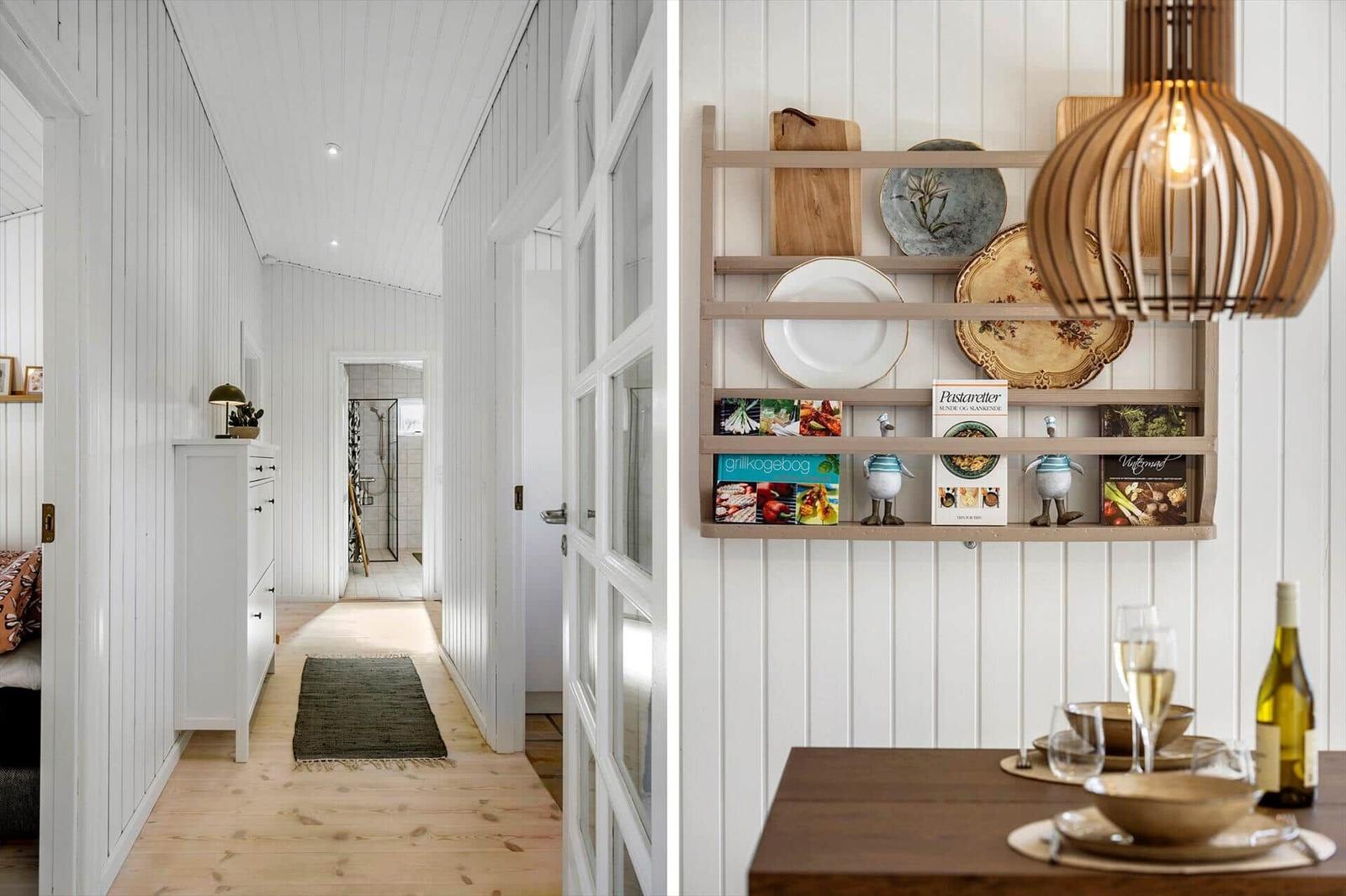 Hallway with cabinet and bathroom, dining area with table, dishes, and lamp