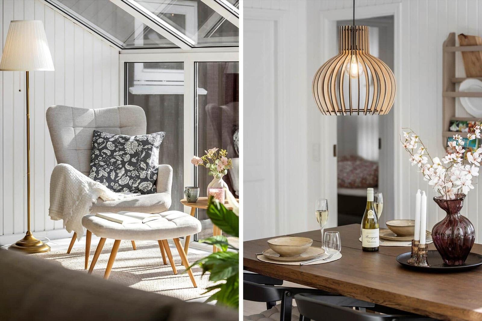 Seating area with armchair and dining table with lamp and flowers.