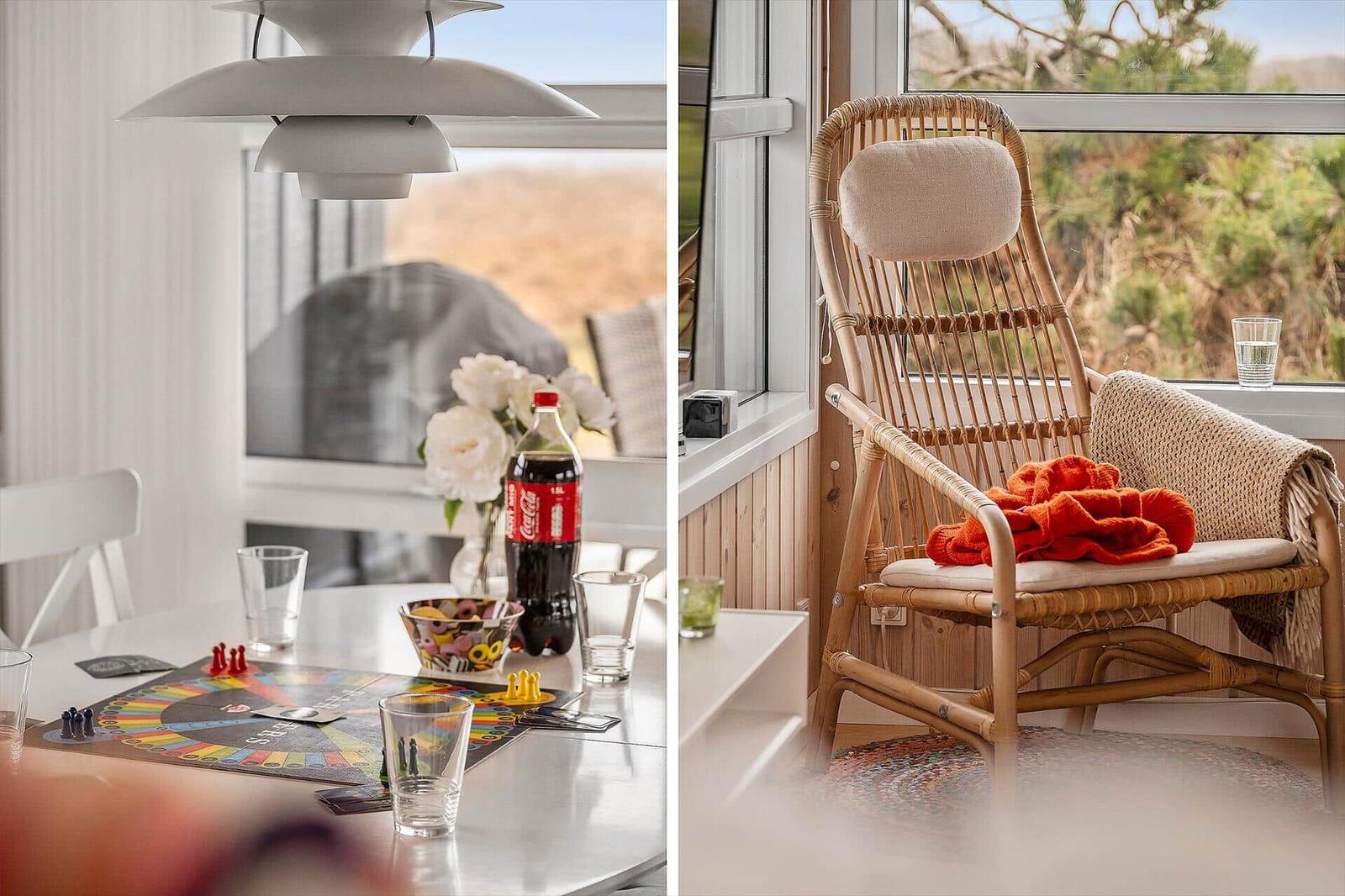 Dining room with game and view. Rattan chair with blanket and water.