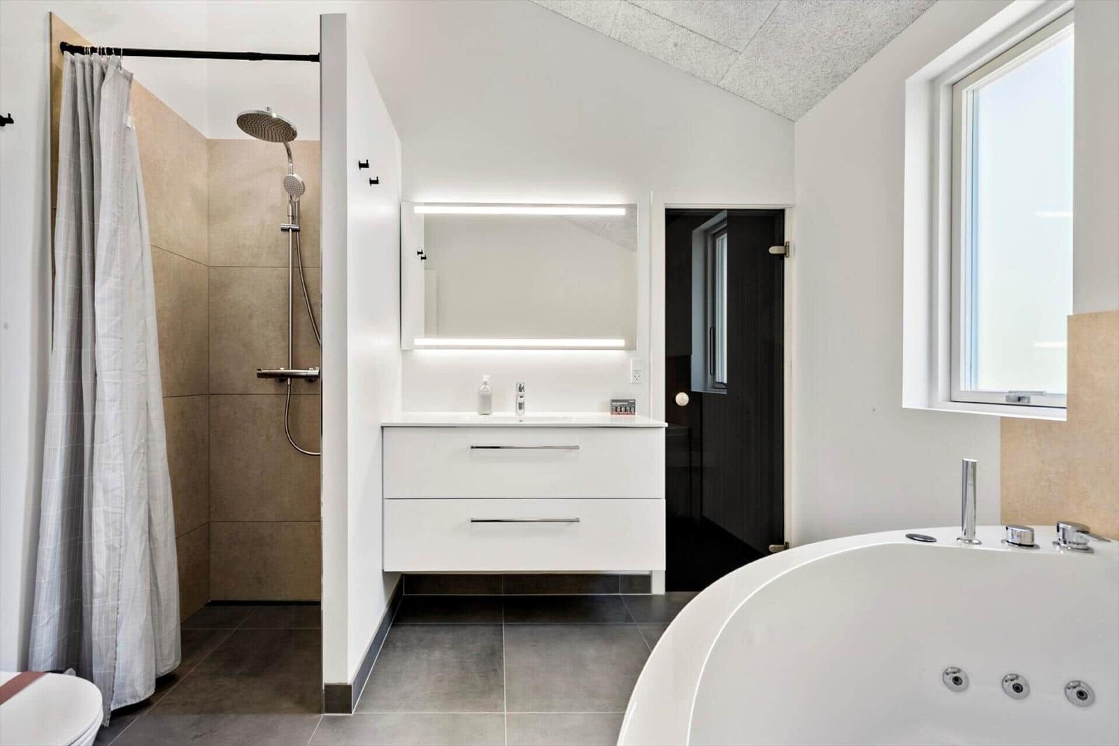 Bathroom with shower, sink and whirlpool tub.