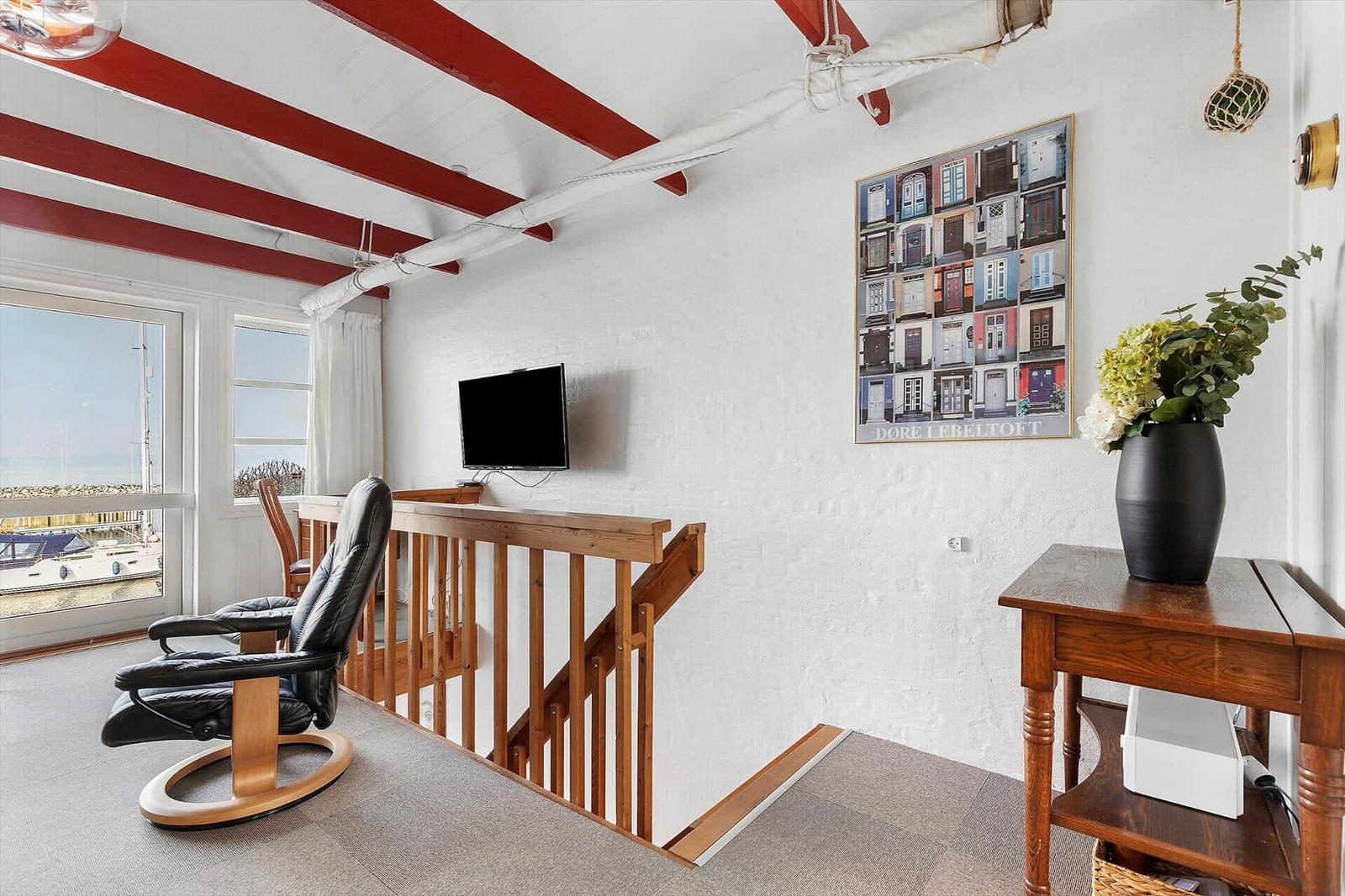 Room with seating, TV, and harbor view