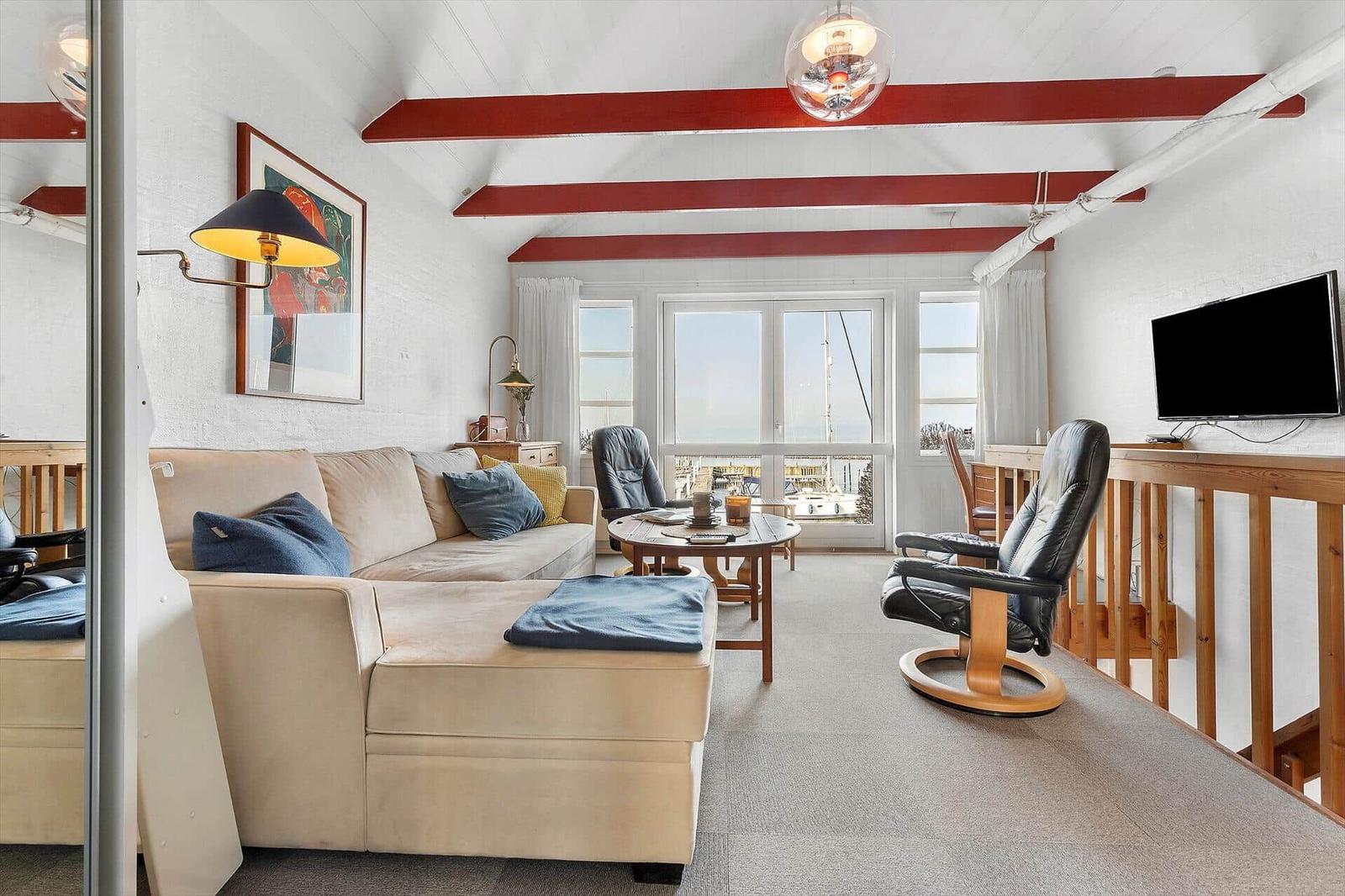 Living room with sofa, chairs, and harbor view