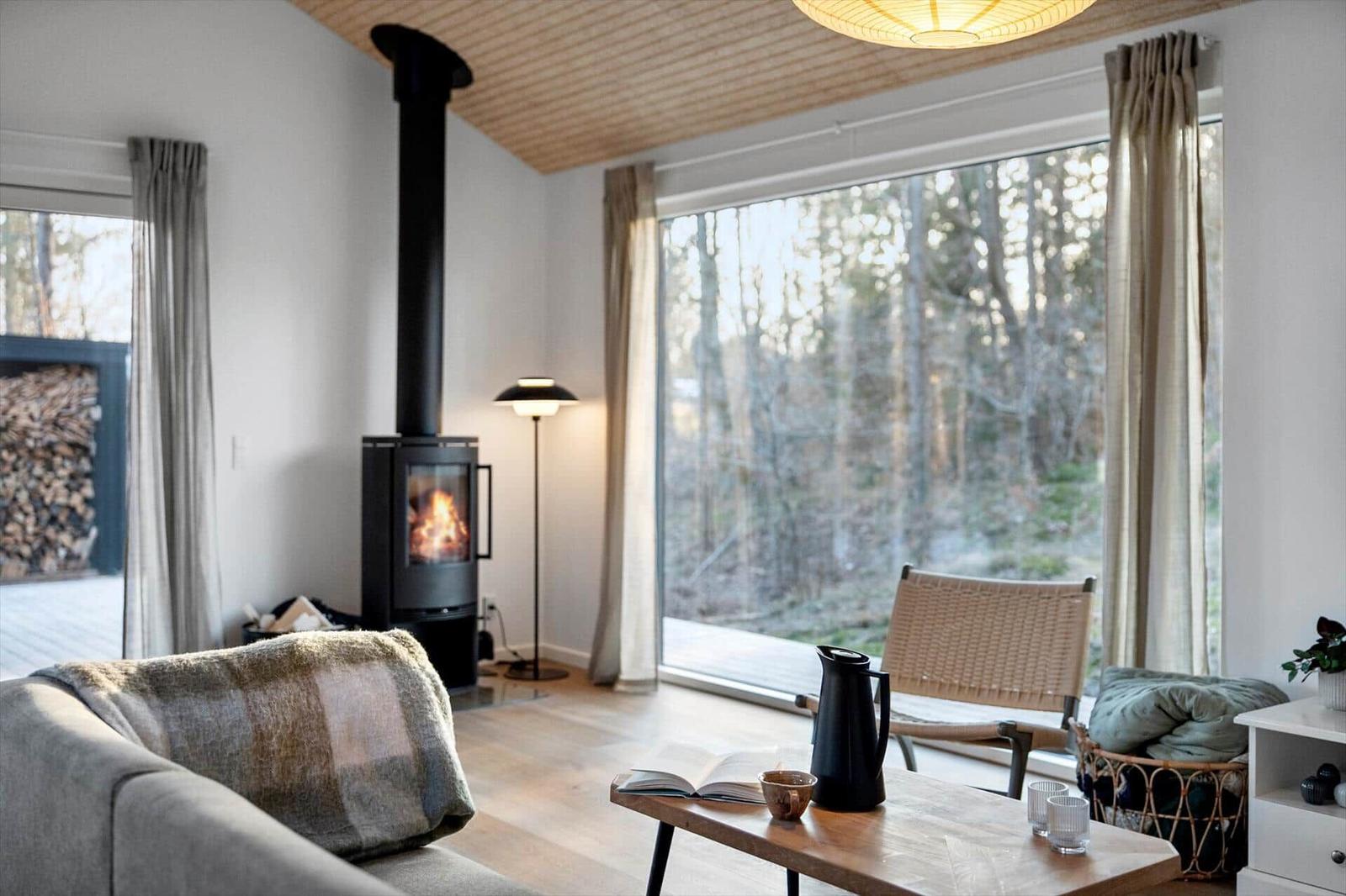 Living room with fireplace, large window, and seating area
