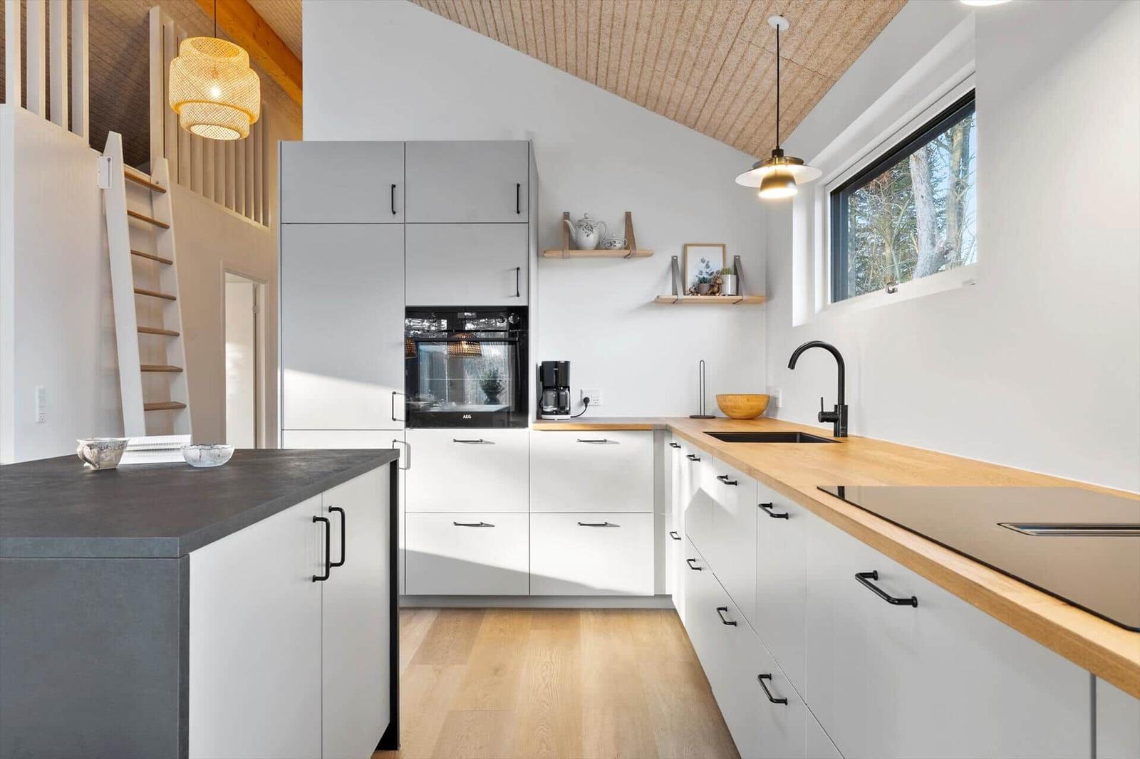 Modern kitchen with wooden surfaces and white cabinets