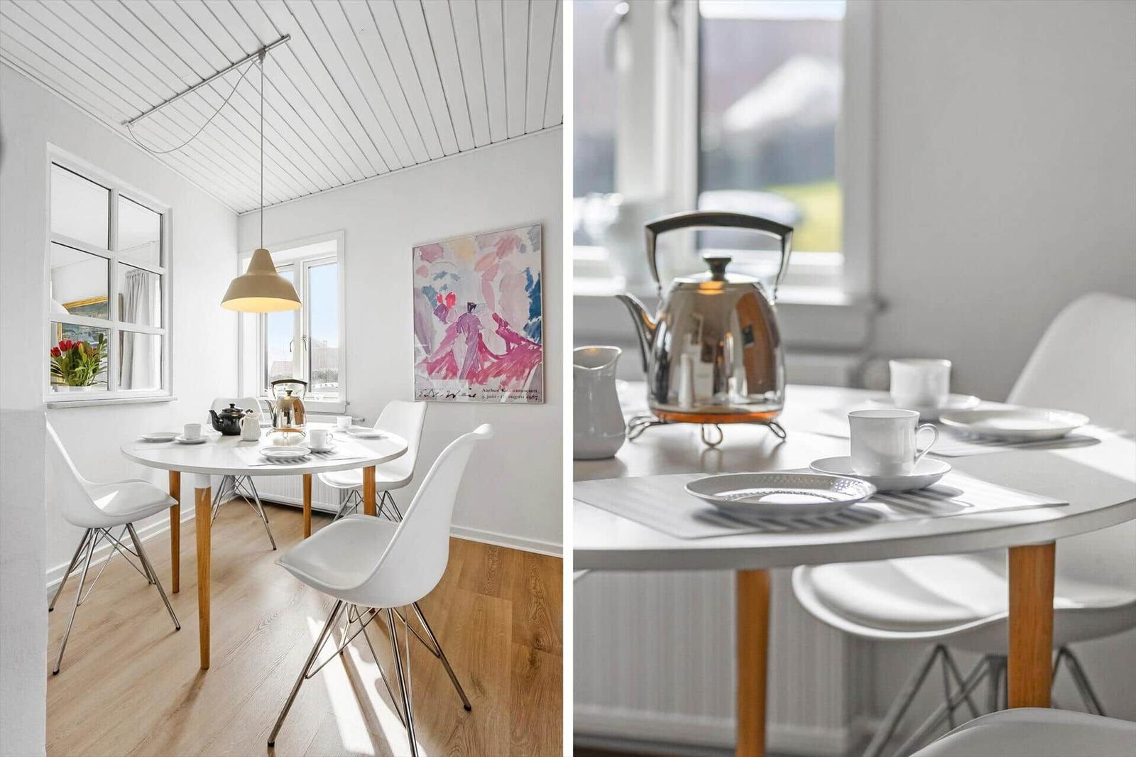 Round table with chairs, kettle and cups in dining room