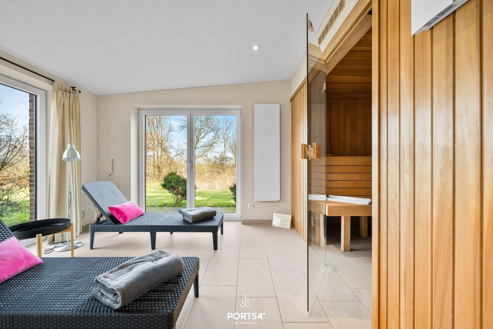 Saunaraum mit Liegen und Blick auf Garten