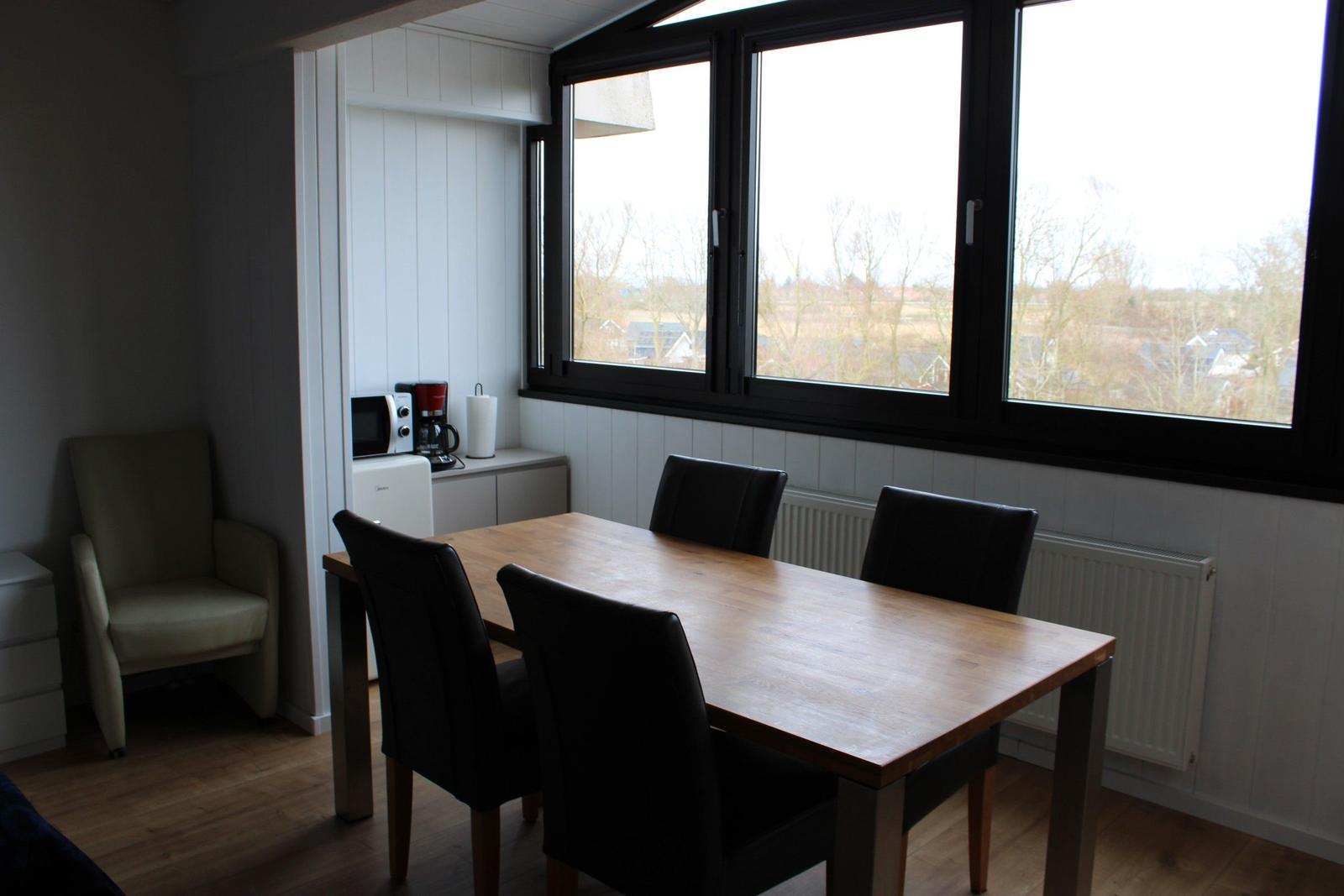 Dining area with table, chairs, and window view