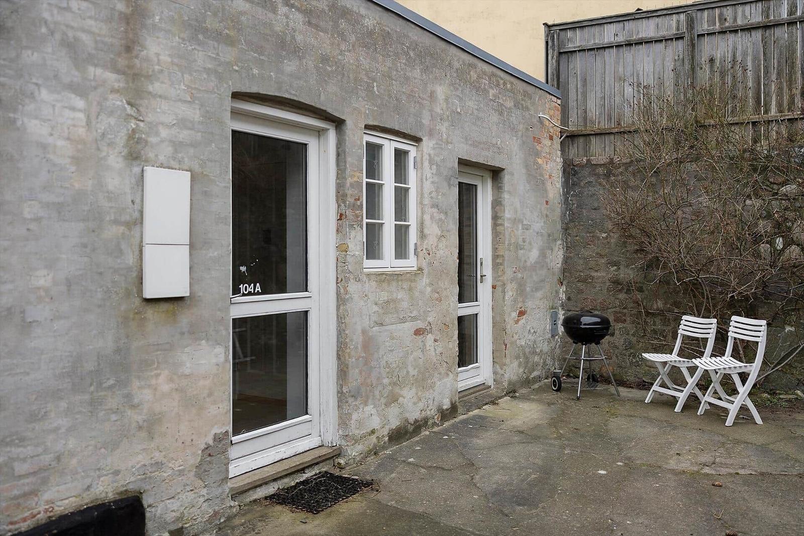 House with entrance door, window and grill area in courtyard