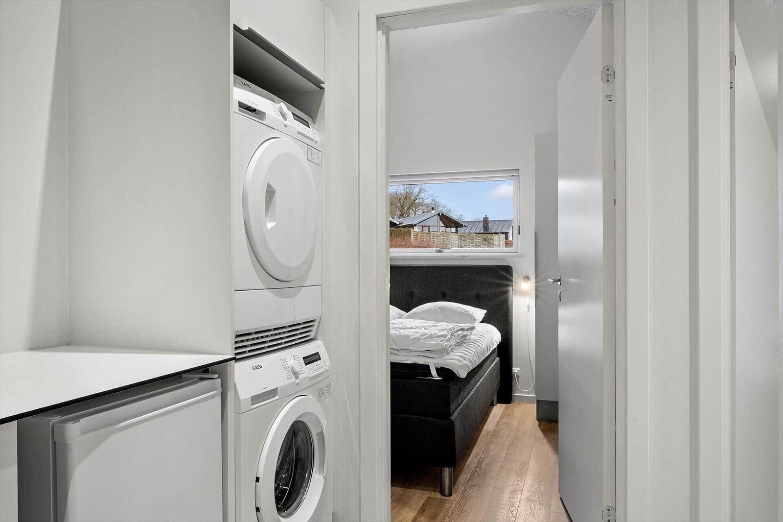 Apartment with washing machine, dryer, and bedroom with window.