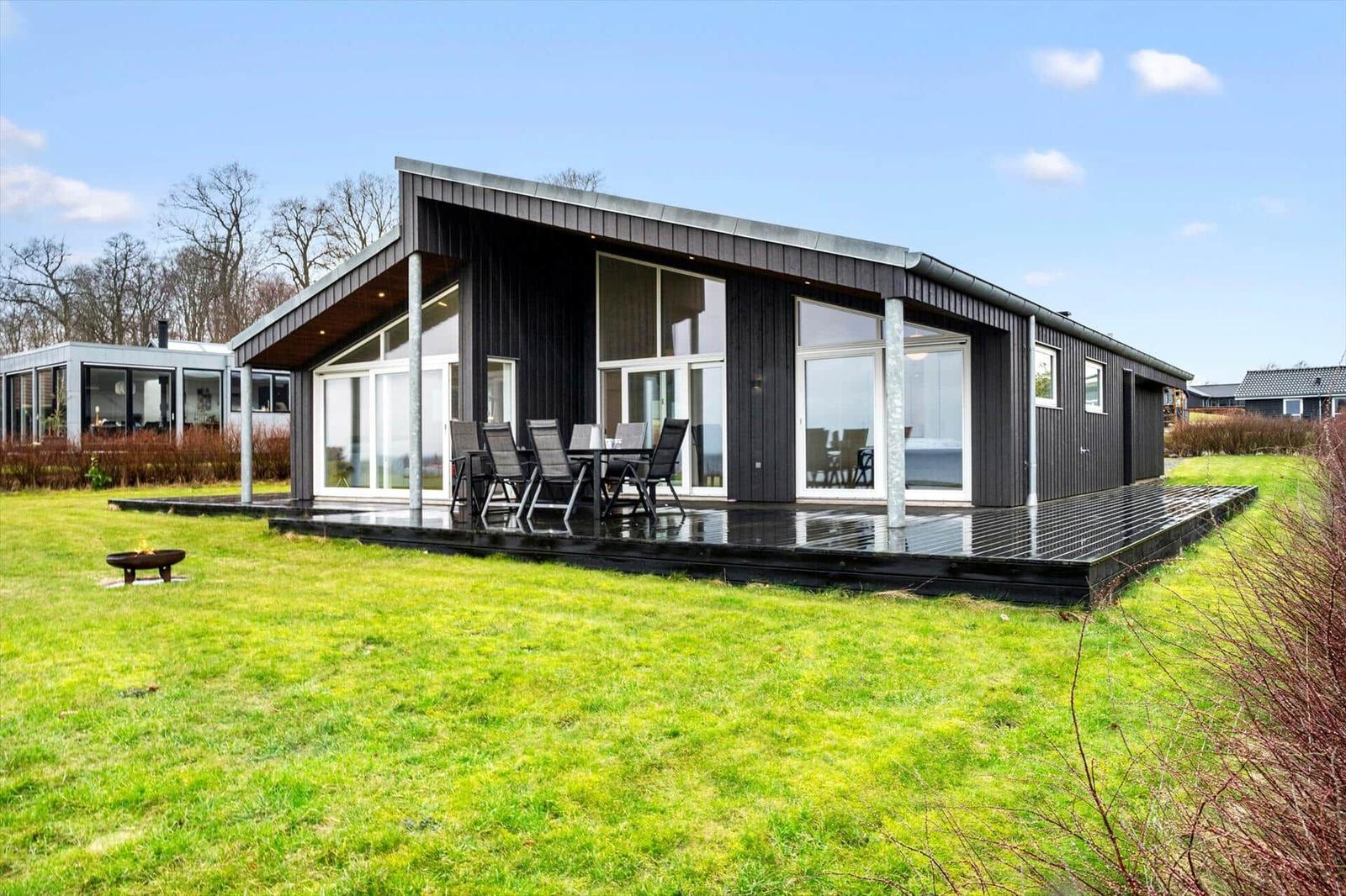 Modern villa with large outdoor terrace and seating area.