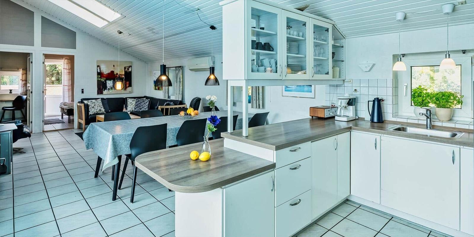 Kitchen with dining area and living room in the background.