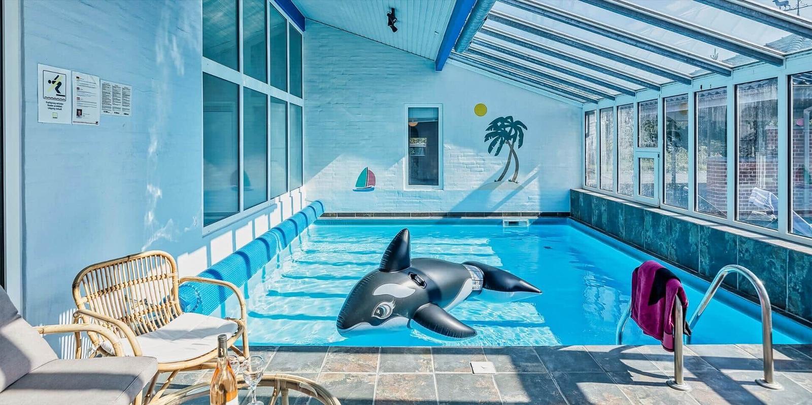 Indoor pool with orca float and seating