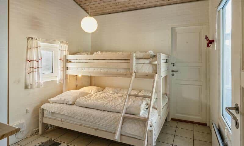 Room with bunk bed, window and door