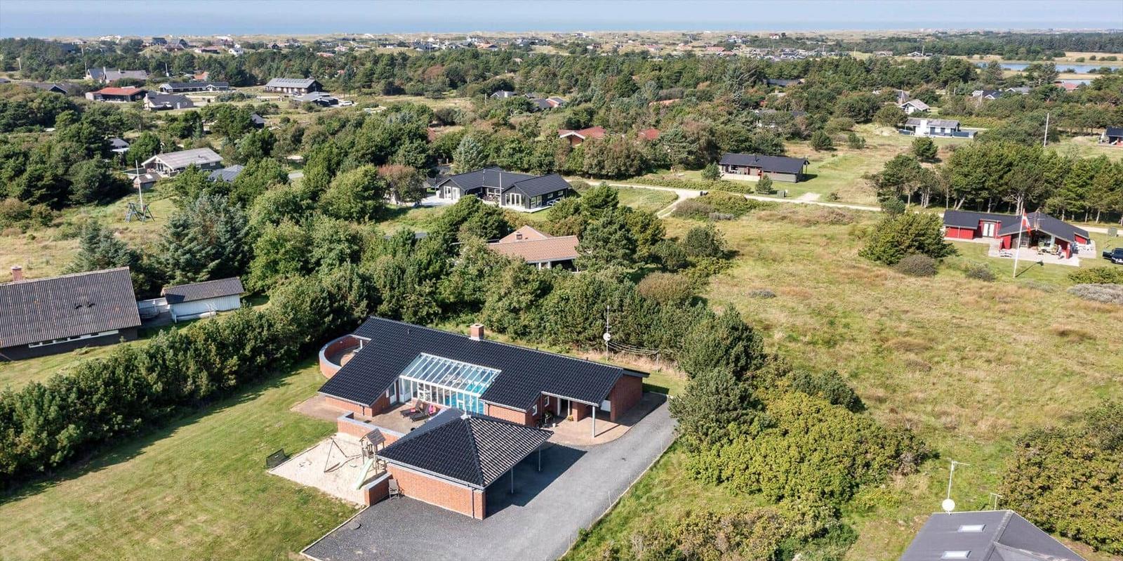 Modern house with pool and large garden in rural setting.